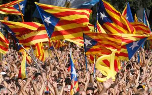 People wave their "Esteladas" (Catalonian separatist flag) flags during a Catalan pro-independence demonstration at Catalunya square in Barcelona