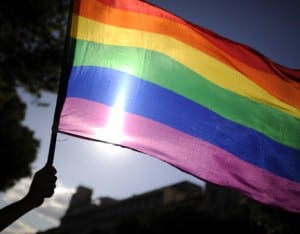 A participants holds a rainbow flag