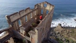 Pic shows: Rubén Alonso Bizarro climbing the top of a ruined building; These are the terrifying images captured by a drone showing a man walking atop the dangerously high walls of a seaside ruin. The dramatic images were captured in the town of Los Realejos on the Spanish island of Tenerife. The video, later shared on YouTube, shows adventure sports enthusiast Ruben Alonso Bizarro walking along the narrow graffiti covered walls of a decrepit building called La Gordejuela. The drone takes in the dramatic scenery around the building, showing the blue sea, black pebbly beach and mountains surrounding the tall ruined building. Bizarro, from the Spanish region of Asturias, walks along until the tallest point of the building at the front where he puts his arms out as if flying. Bizzaro is a lover of "sports and the good life" according to his Instagram page where he uploads many pictures of himself on thrilling adventure holidays amidst the amazing scenery of the volcanic island. . He has a following of more than 3,500, who comment admiringly on his post One user wrote: "Wow congratulations on the video, amazing." Whilst another commented: "The more I see it the more vertigo I get!";