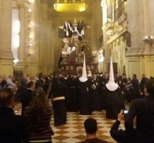 SACRED: Nazarenos and spectators congregate in church