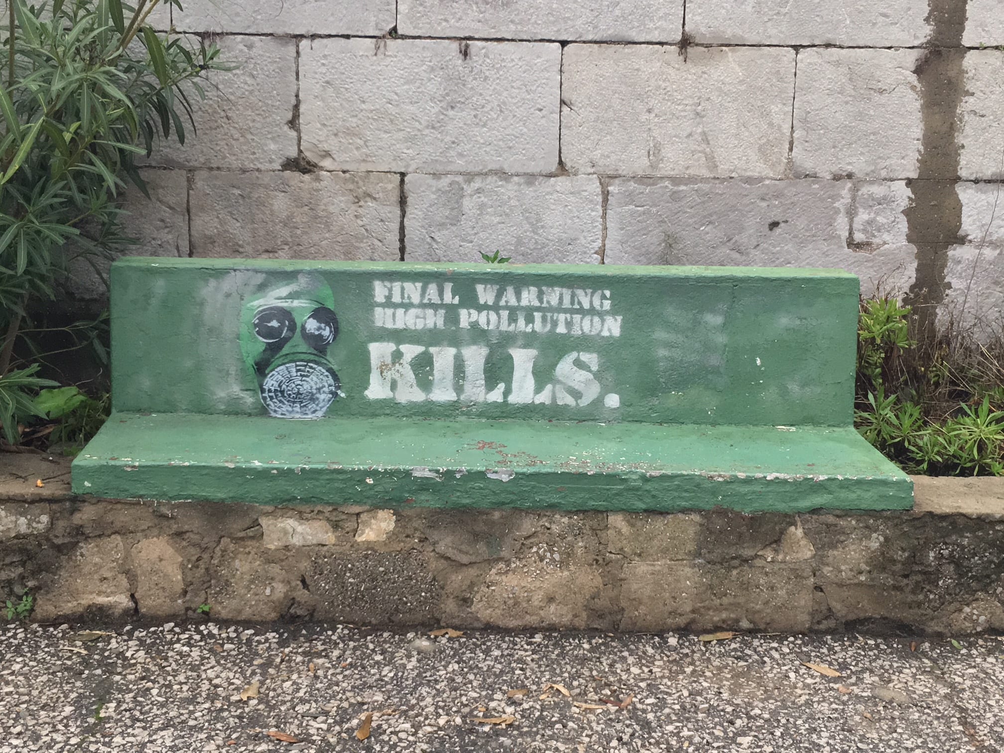 Pollution graffiti on bench in Gib