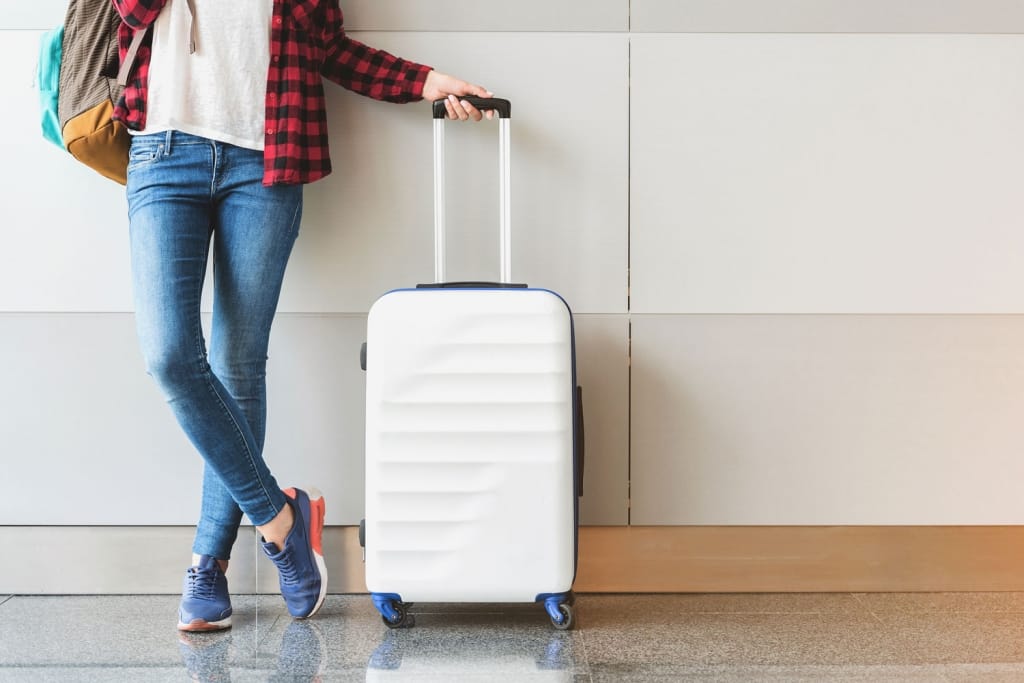 Woman Luggage Airport Shutterstock_683275162 1024x683