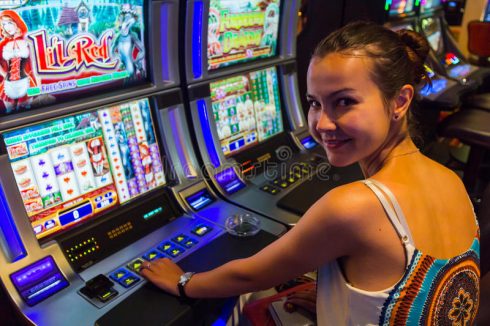 Smiling Woman Playing Slot Machines