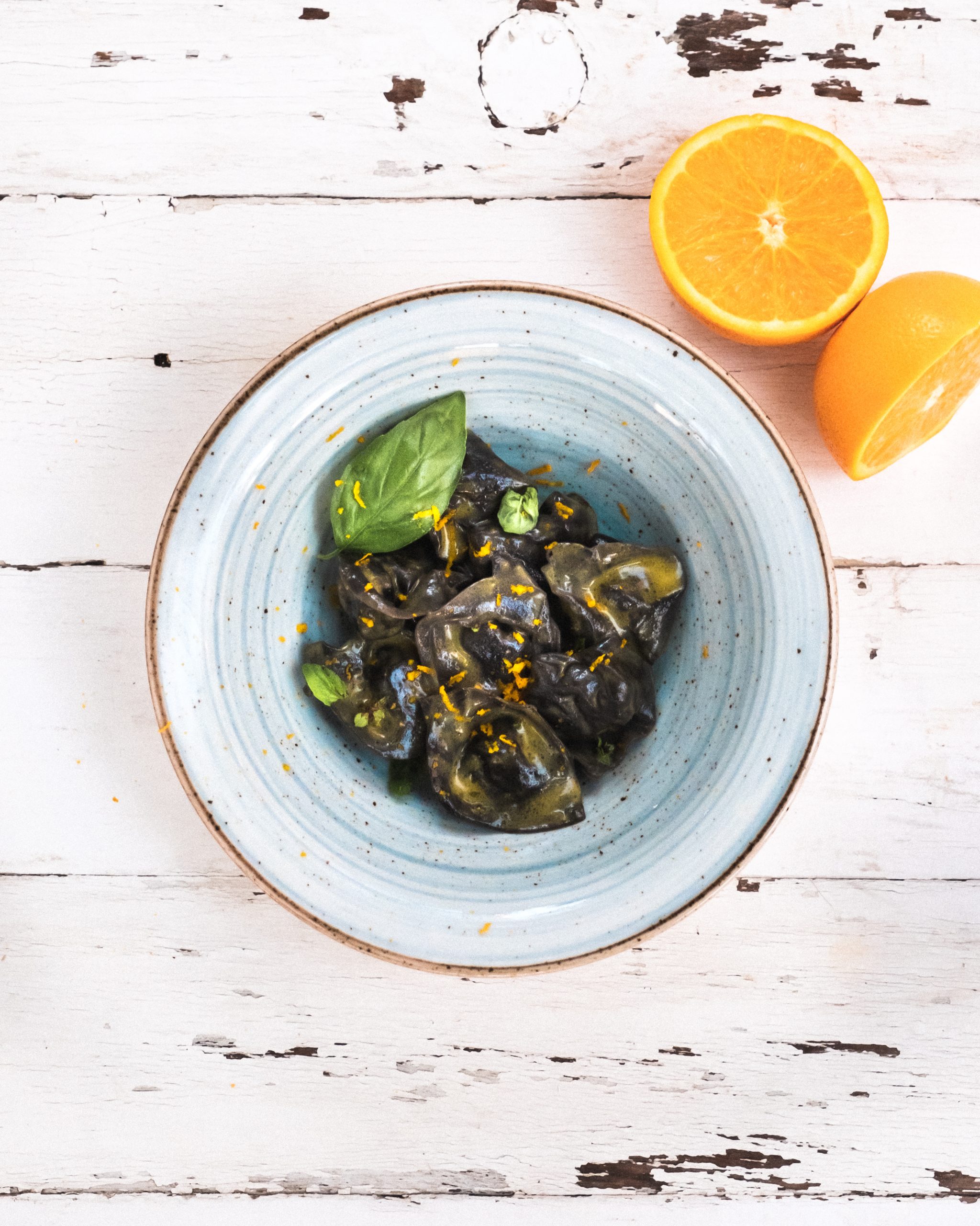 Squid Ink Raviolo Stuffed With Bream Basil And Orange Shavings
