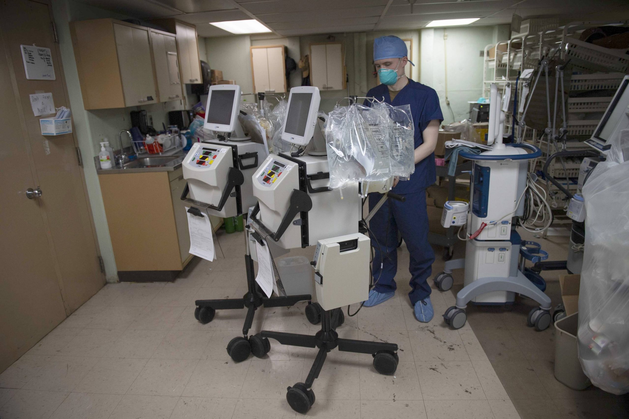 A doctor preparing a dialysis machine