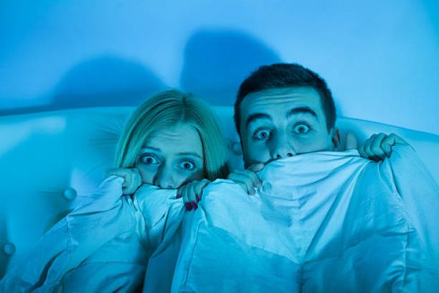 Frightened Couple Watching A Horror Movie