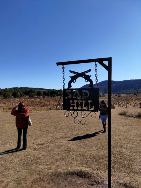 Sad Hill Sign With Guns