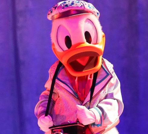 Donald Duck run over by children's train at Valencia area fair in Spain