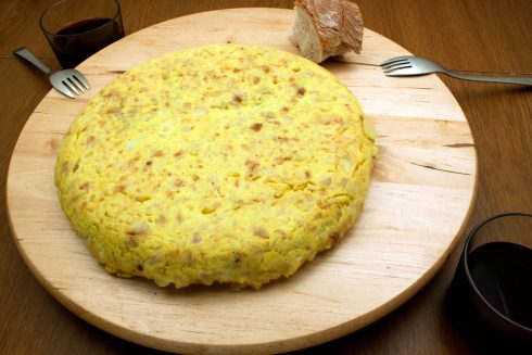 An Spanish Omelet With Two Glasses Of Red Wine