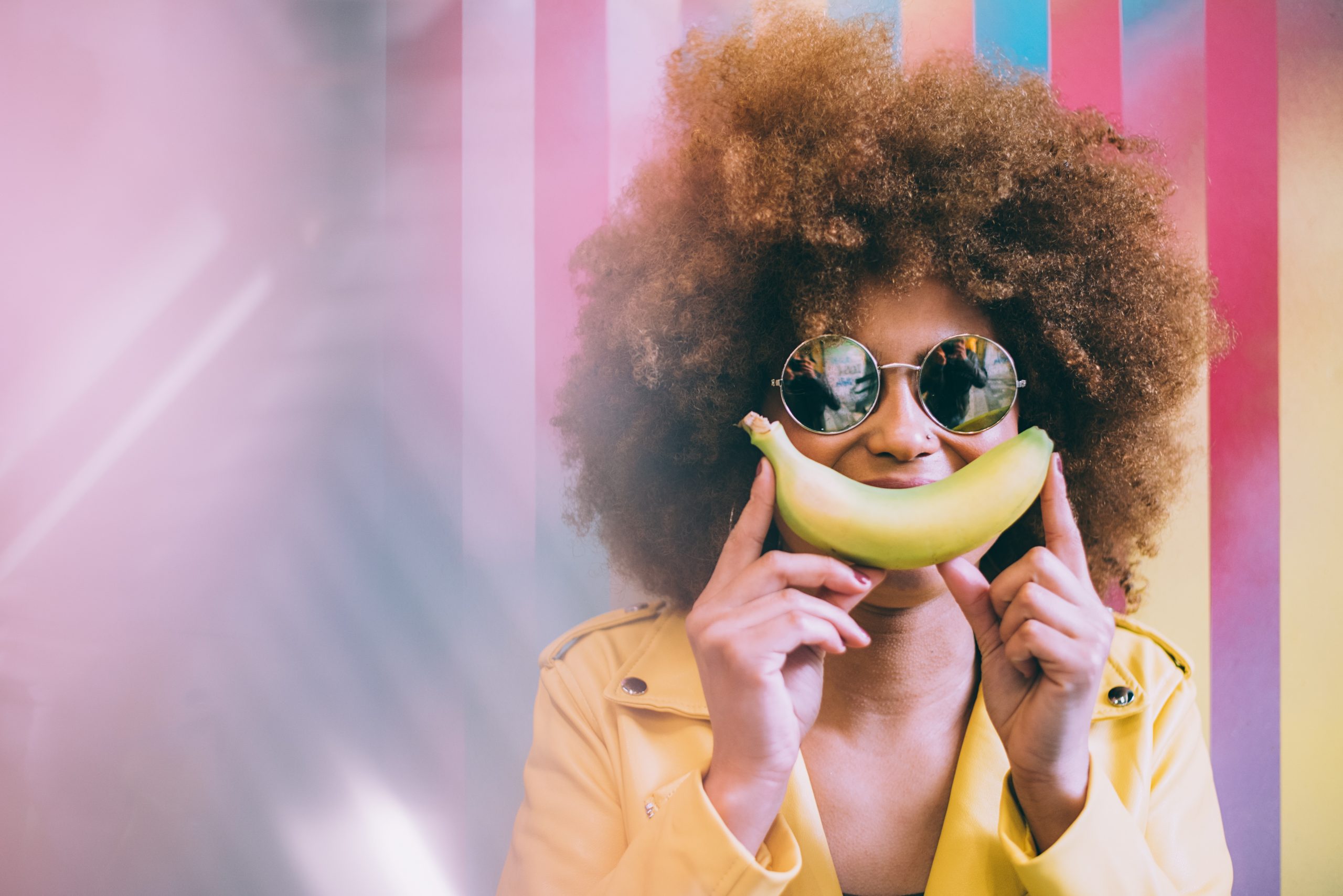 Surprised Mixed Race Woman In A Colorful Artwork Background Wall