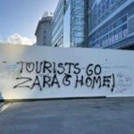 'Go to Zara and go home!' New 'anti-tourism' graffiti appears on Spain's northern coast as destination surges in popularity